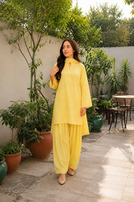 Pastel yellow 2-piece women’s suit with wide sleeves and scalloped detailing by Noor By Nureh